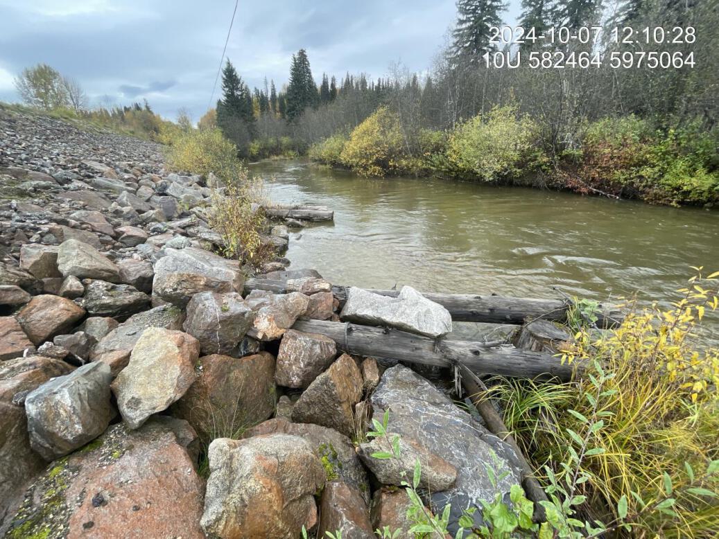 Ripwrapped banks and large wood structures secured with metal wiring located downstream of crossing 199256.